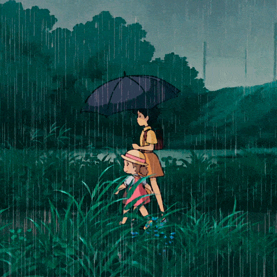 gif 2 of 5. two girls walk on a greenery scenario while it's raining. the older one is holding an umbrella. Satsuki is the oldest and Mei is the youngest, a toddler.