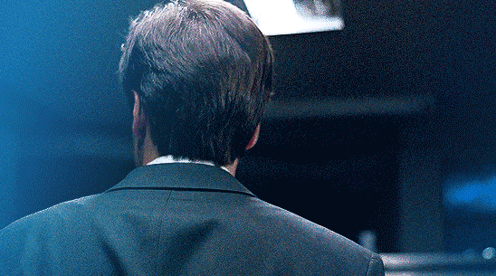 gif 7 of 14. someone holding a knife slits Mulder's throat while behind his back. Mulder touches his wound in agony. the color blue is prominent in the gif.