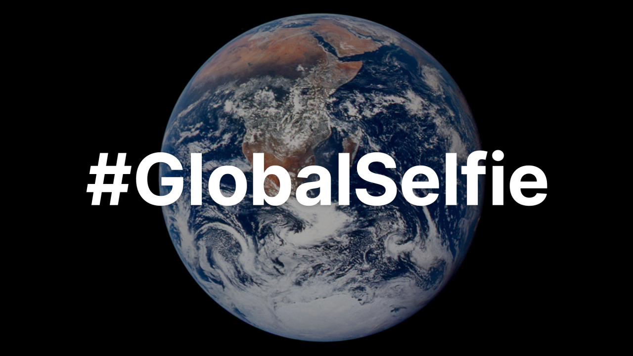 The hashtag #GlobalSelfie is overlaid on the "Blue Marble" image of Earth -- the first image from space that shows the entire planet. Africa, Antarctica, and the deep blue ocean are visible beneath swirling white clouds. Credit: NASA