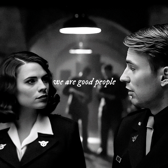 gif 2 of 3. Steve and Peggy look at each other and smile. they are wearing military uniforms. the gif starts as a black and white one but slowly gains color. "we are good people", the text says.