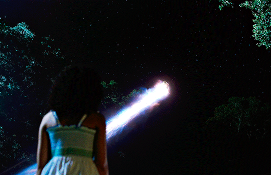 gif 5 of 6. Carol is seem flying through the night sky, looking like a shooting star. a young Monica is watching her leave. end ID.