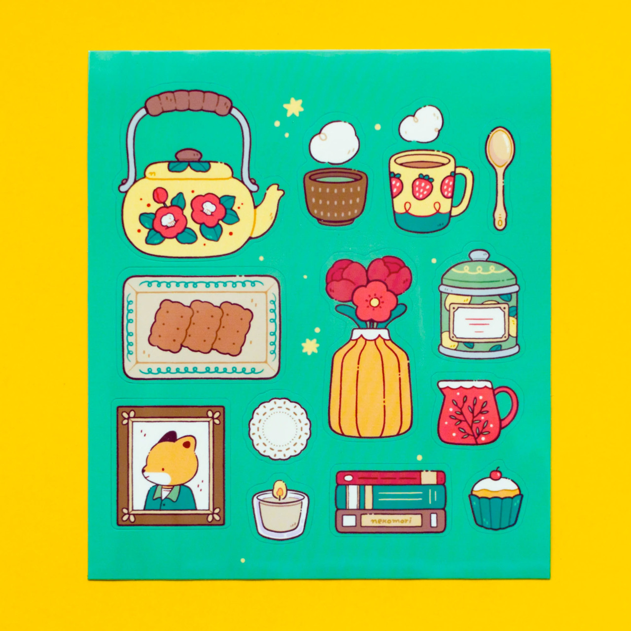 Sticker sheet depicting various items that might be found in a tea party, such as teapots and cups, snacks, and stacks of books.