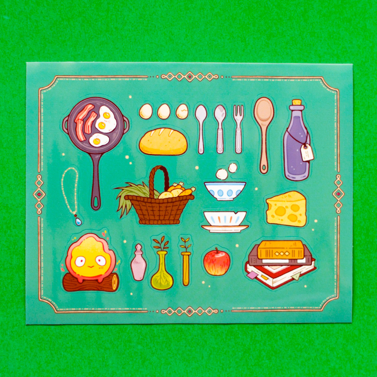 Sticker sheet depicting various items that might be found in Howl's moving castle, such as a happy Calcifer on a log, some books, potion bottles, and cooking utensils.