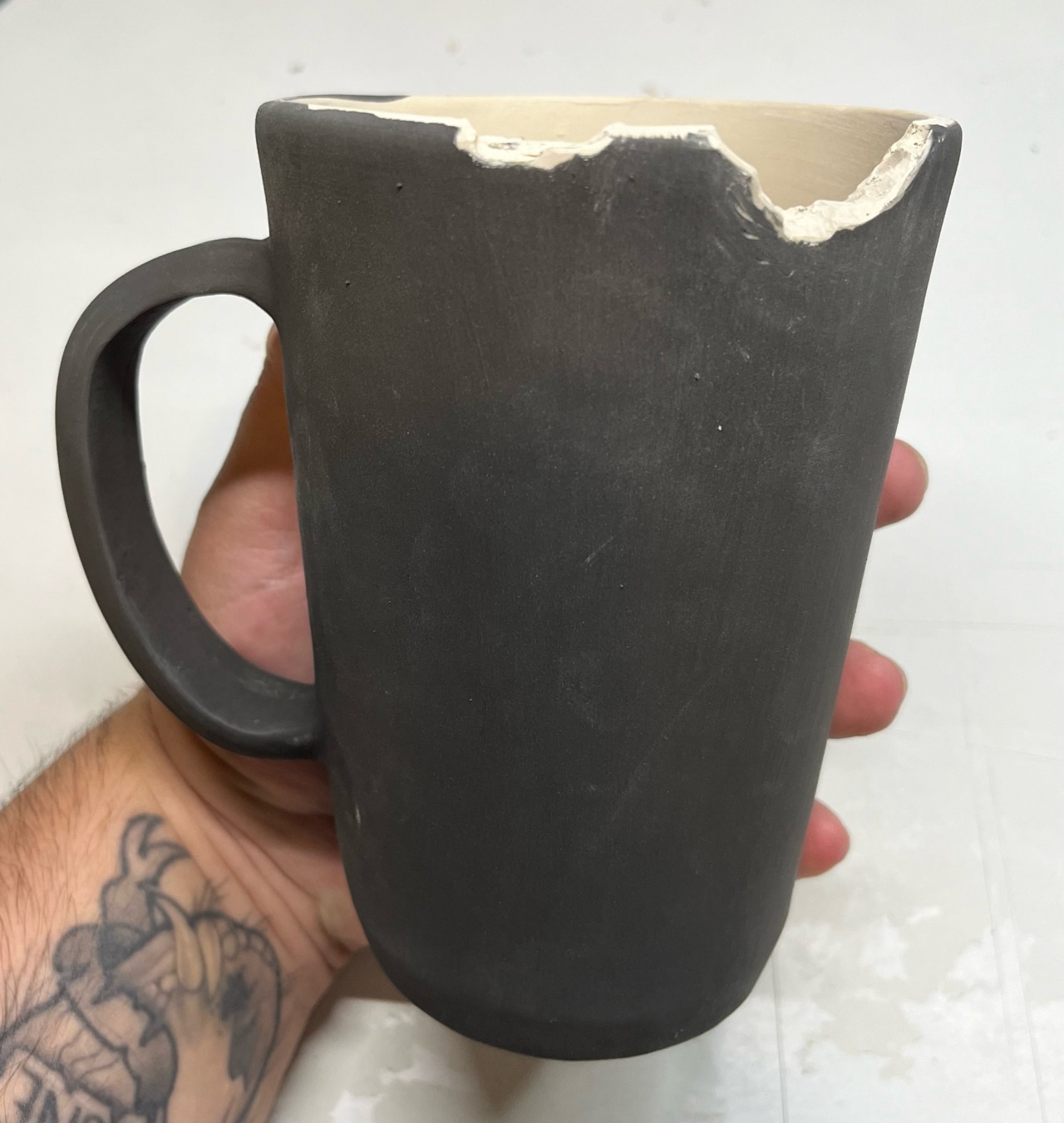 the other side of the mug. there are two bites out of the rim