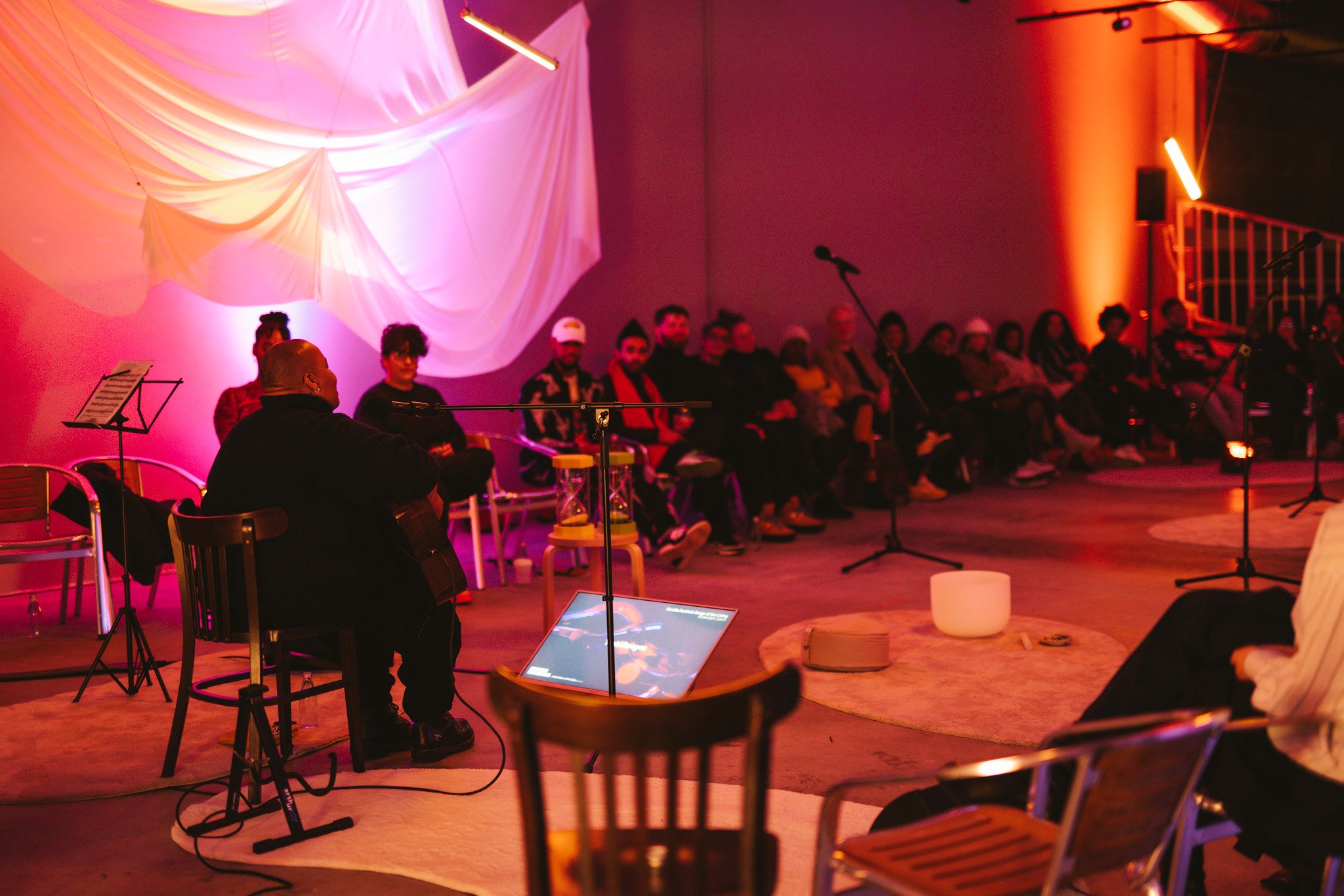 A photo of the stage and audience at Songs of the Living Event in Rotterdam 2024