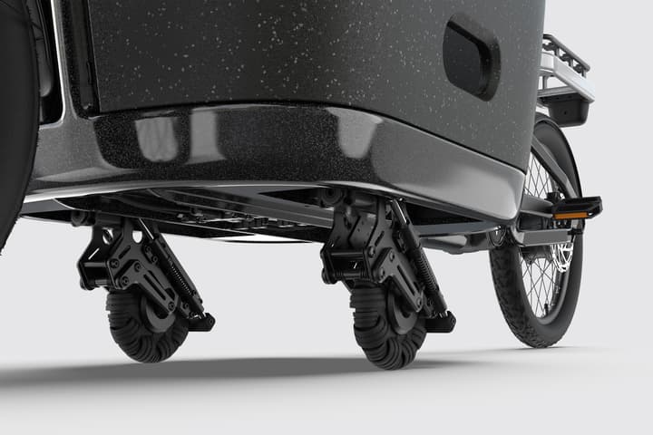Stabilizing wheels on the underside of the cargo box are deployed automatically when the rider brakes for low-speed travel