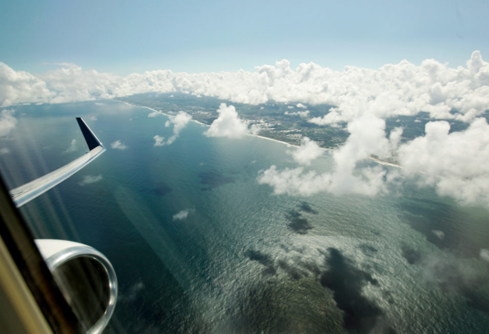 view from the airplane window during overflight at sea, in the city of Lauro de Freitas