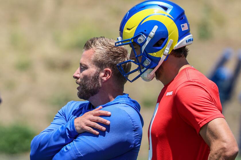 Rams  coach Sean McVay talks with quarterback Matthew Stafford at the last day of OTA practice at Cal Lutheran University.