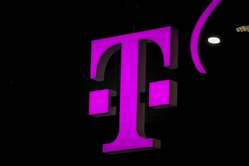 FILE - T-mobile logo in the Mobile World Congress 2023 in Barcelona, Spain, on Thursday, March 2, 2023. On Tuesday, May 28, 2024, T-Mobile is buying U.S. Cellular's wireless operations and certain spectrum assets in a deal valued at $4.4 billion. (AP Photo/Joan Mateu Parra, File)