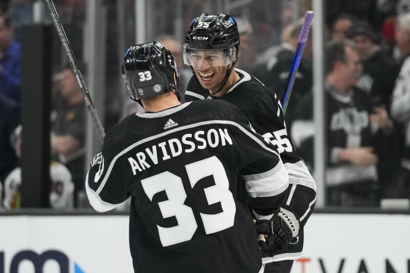 Los Angeles Kings right wing Viktor Arvidsson (33) celebrates with right wing Quinton Byfield (55) after scoring during the third period of an NHL hockey game against the Chicago Blackhawks Thursday, April 18, 2024, in Los Angeles. (AP Photo/Ashley Landis)