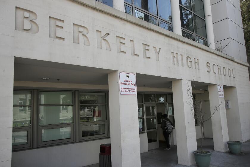 A student walks into Berkeley High School in Berkeley, Calif., Thursday, April 11, 2019. The first online election for student government at Berkeley High School became a lesson in more than democracy. Students also learned about vote fraud, hacking and digital privacy after a high school junior who was running for class president cast hundreds of fake online votes for himself. (AP Photo/Jeff Chiu)