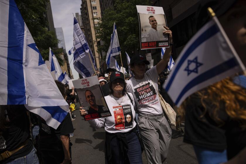 People hold Israeli flags gather ahead of the annual Israel Day Parade on Sunday, June 2, 2024, in New York. (AP Photo/Yuki Iwamura)