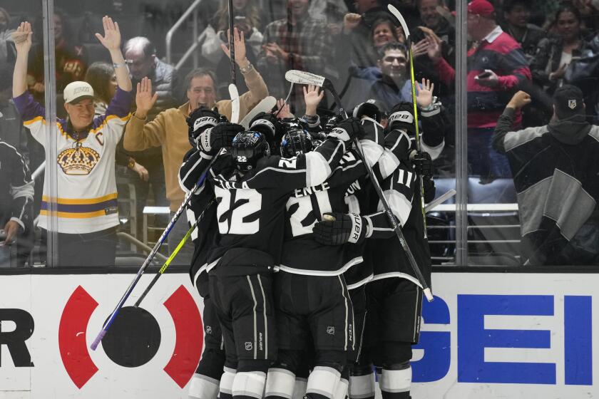 The Los Angeles Kings celebrate after right wing Adrian Kempe scored during overtime.