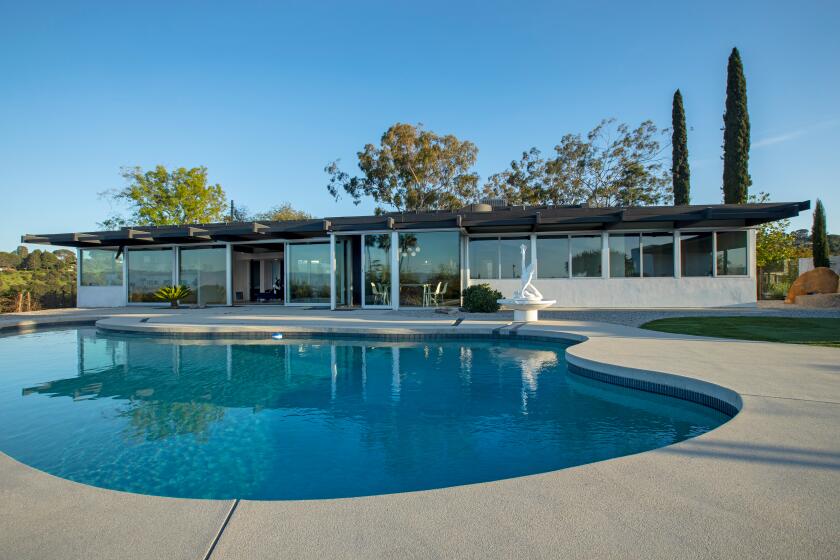 SHERMAN OAKS, CA - APRIL 6, 2023 - Swimming pool in the backyard of a Richard Neutra's design house renovated and restored to it's original design by owners, architect team, Dora Chi & Erik Amir (of the firm Spatial Practice), photographed on April 6, 2023, Sherman Oaks, CA. In 1961, prolific TV writer & composer Stephen Lord (CHiPs, Fantasy Island, etc.) commissioned mid-century modernist architect Richard Neutra to design a home on a 26,500-square-foot promontory lot with jetliner views toward the Santa Monica Mountains overlooking the San Fernando Valley and beyond. The property is located off Mulholland Drive at the end of a private road. Husband & wife architect team, Dora Chi & Erik Amir discovered the single-floor home in 2021 gutted and dilapidated. Not much is known about this house but the bones of the house are classic Neutra: a floating roof plane sliding over smooth stucco vertical planes with strong horizontal lines, centralized freestanding fireplace with a floating hearth, and walls of glass framing views. Working together with Lord's daughters, the architects renovated the property to restore Neutra's design, modernize the kitchen and bathrooms. They also added a contemporary pavilion featuring a guest house and deck that appears to float over the hillside. (Ricardo DeAratanha / Los Angeles Times)