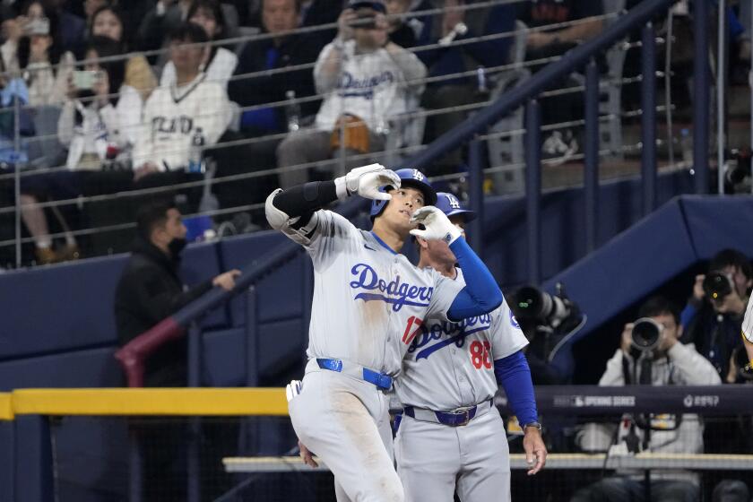 Los Angeles Dodgers designated hitter Shohei Ohtani gestures after hitting a single during the third inning of an opening day baseball game against the San Diego Padres at the Gocheok Sky Dome in Seoul, South Korea Wednesday, March 20, 2024, in Seoul, South Korea. (AP Photo/Ahn Young-joon)
