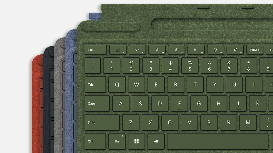Five Surface Pro Signature Keyboard devices in various colors.