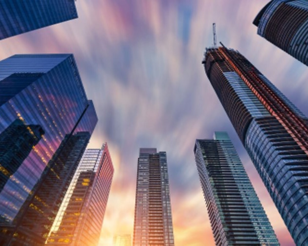 日落时分，彩色天空下的现代摩天大楼的天际线，以及动态的云彩的运动。