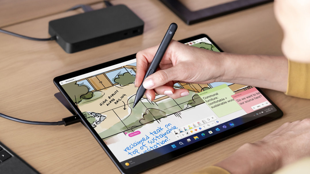A person is observed using a Surface Slim Pen on the screen of a Pro device