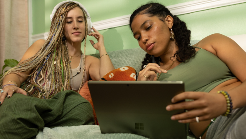 Two girls browse online using a Microsoft Surface