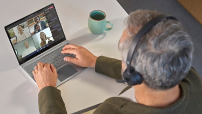 A man working from home on a Surface Laptop Go 3.