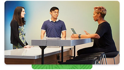 Three Microsoft employees having a conversation in a common break room