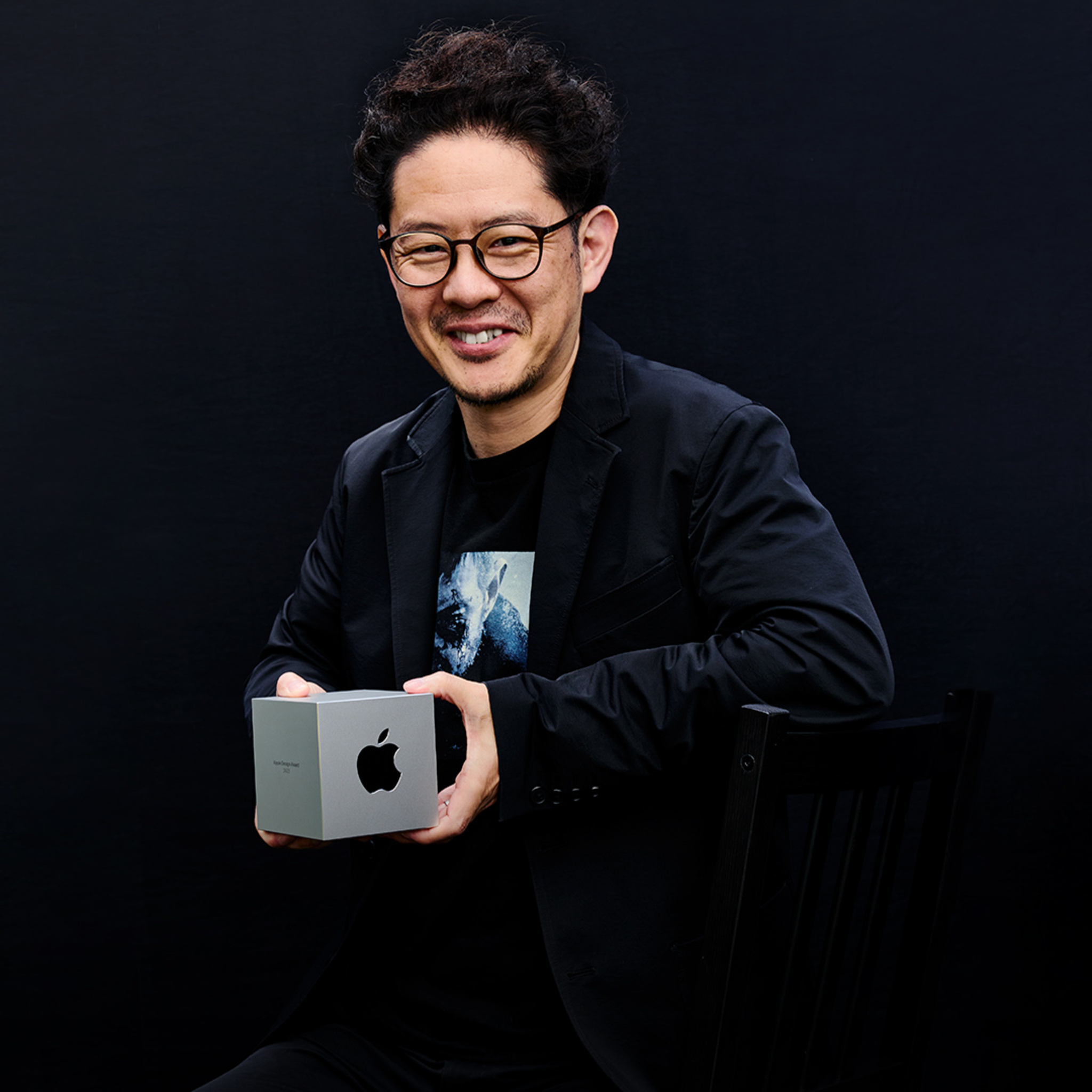 A photo of Resident Evil Village producer Tsuyoshi Kanda holding his team’s Apple Design Award.