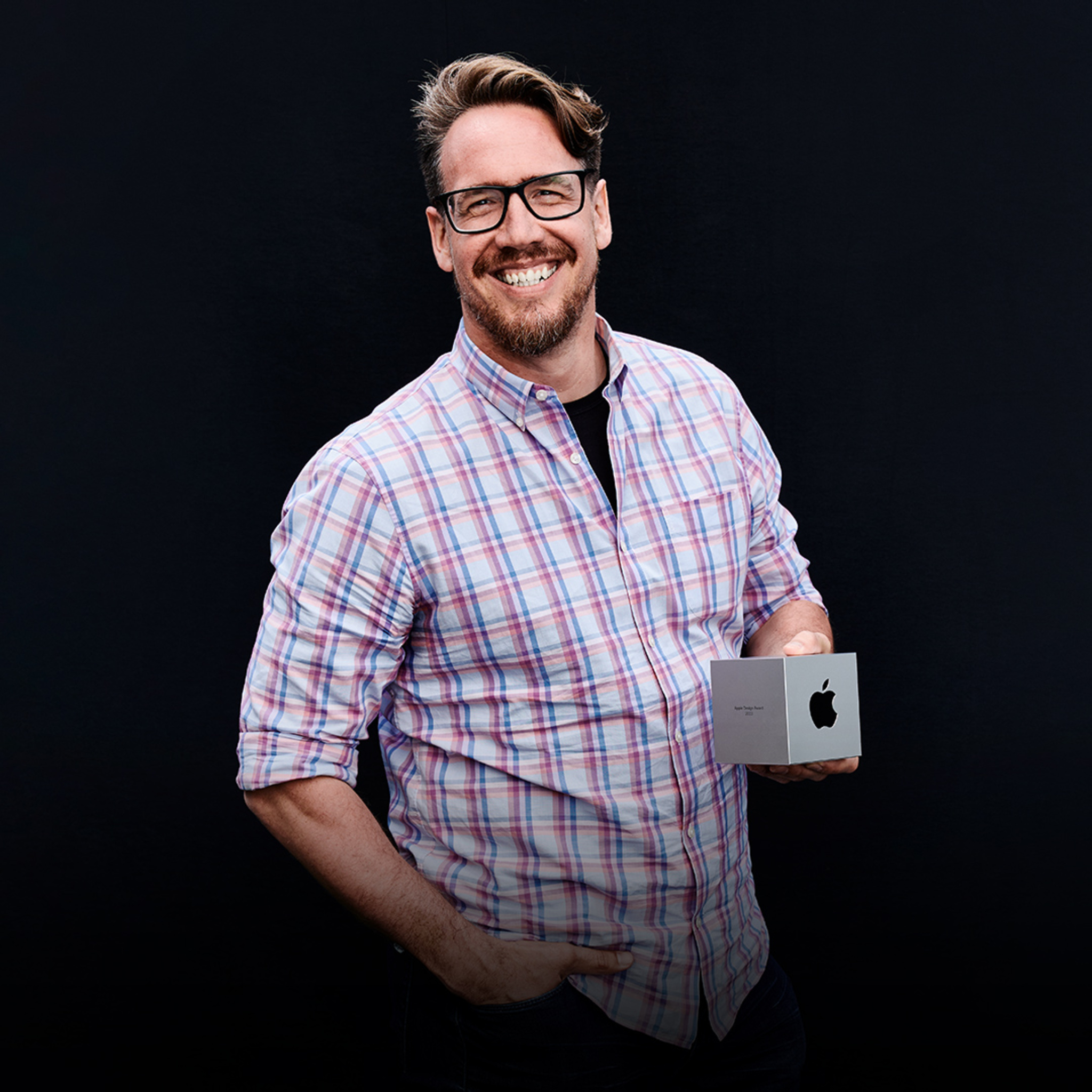 A portrait of Ben Brode, creator of MARVEL SNAP, holding his Apple Design Award.