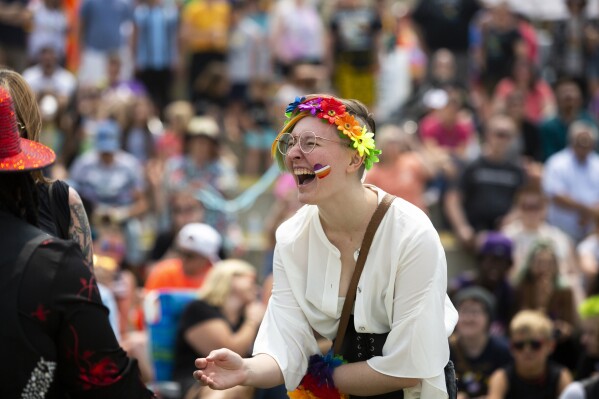 FILE - A Grand Haven Pride Fest attendee is seen cheering during a drag show at the Lynne Sherwood Waterfront Stadium in Grand Haven, Mich., on Saturday, June 10, 2023. Pride Month starts Saturday, June 1, 2024, across the U.S. and the globe, an annual celebration of LGBTQ+ people and culture. The main events are parades and festivals held in cities large and small. (AP Photo/Kristen Norman, File)