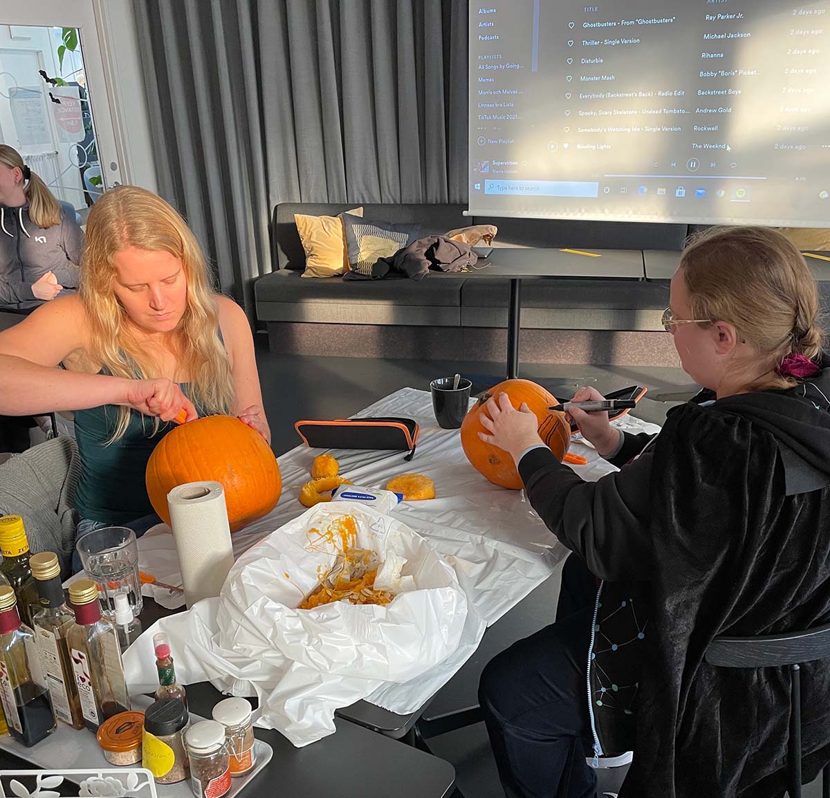 two people carving pumpkins