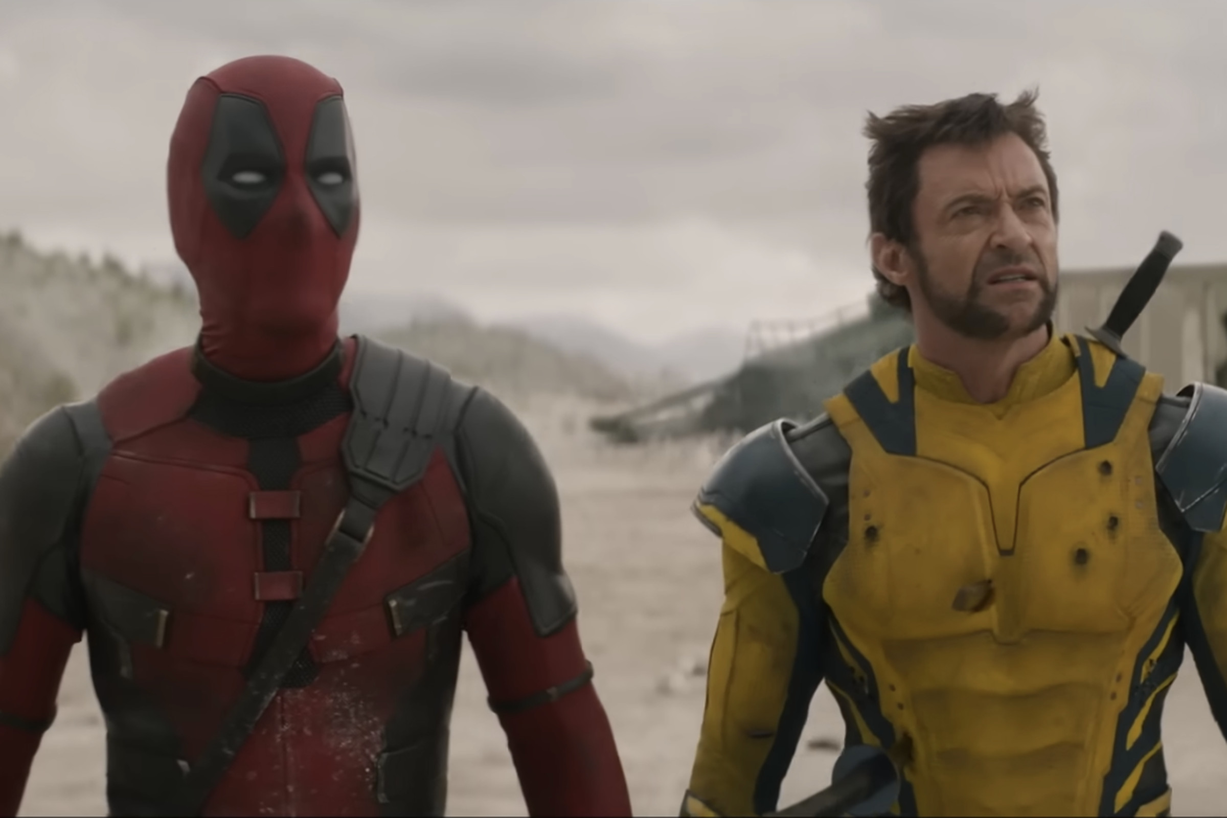 A picture of Deadpool and Wolverine looking upward at something behind the camera.