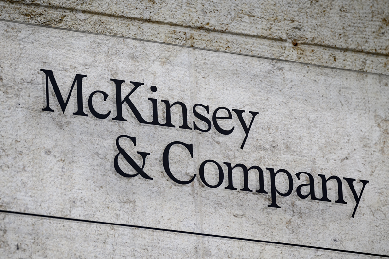 A sign for the U.S.-based McKinsey & Company management consulting firm is seen on a wall in Geneva, carved in a serif font in an expanse of gray stone.