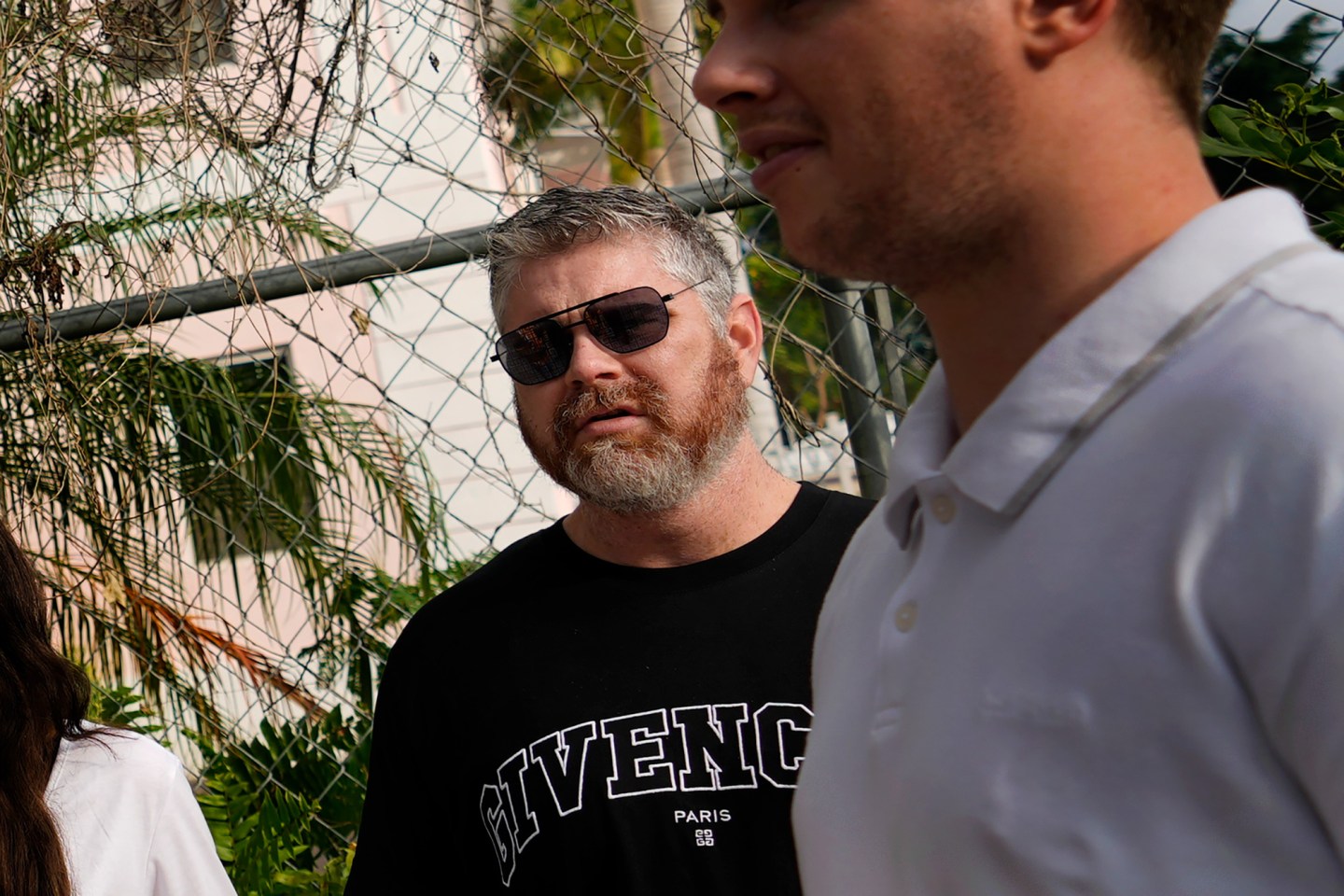A group of crypto enthusiasts, including influencer Ben Armstrong, second right, known as &#8220;BitBoy Crypto,&#8221; wait to enter Magistrate Court to see a scheduled appearance by FTX founder Sam Bankman-Fried, in Nassau, Bahamas, Monday, Dec. 19, 2022. Armstrong, who traveled to the Bahamas with a group that included investors who lost their life savings, said he wants to see Bankman-Fried &#8220;face the music.&#8221; (AP Photo/Rebecca Blackwell)