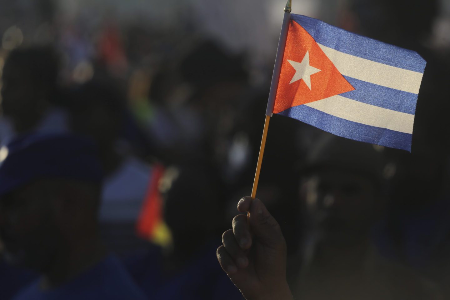 A person waves a Cuban flag during a gathering marking International Workers&#8217; Day at Jose Marti<br />
Anti-Imperialist Square in Havana, Cuba, Wednesday, May 1, 2024. (AP Photo/Ariel Ley)