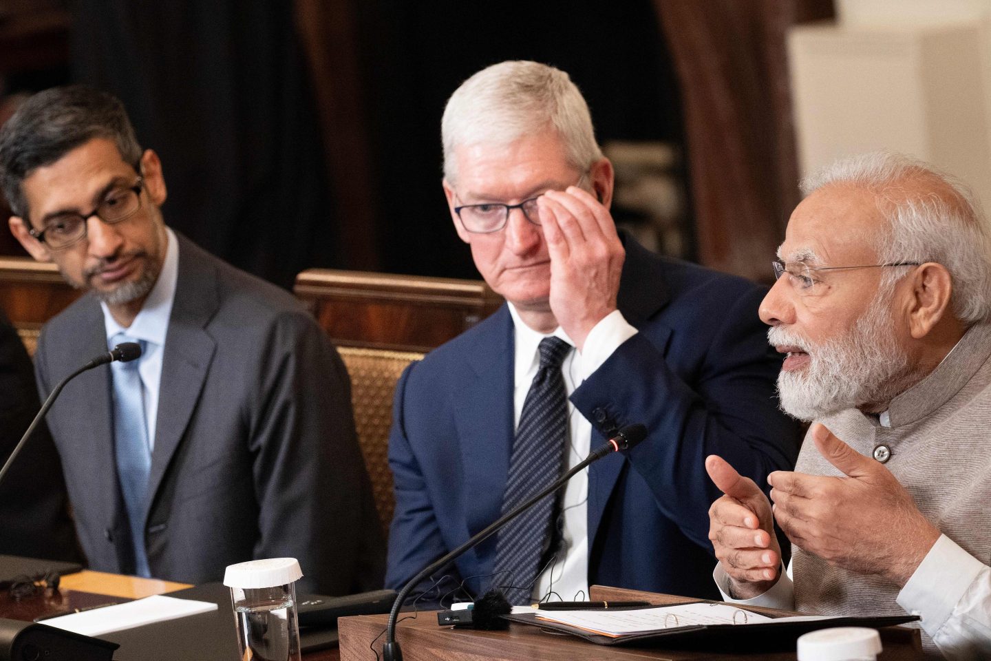 Google CEO Sundar Pichai and Apple CEO Tim Cook look on as India's Prime Minister Narendra Modi speaks during a meeting with senior officials and CEOs of American and Indian companies, in the East Room the White House in Washington, DC, on June 23, 2023.