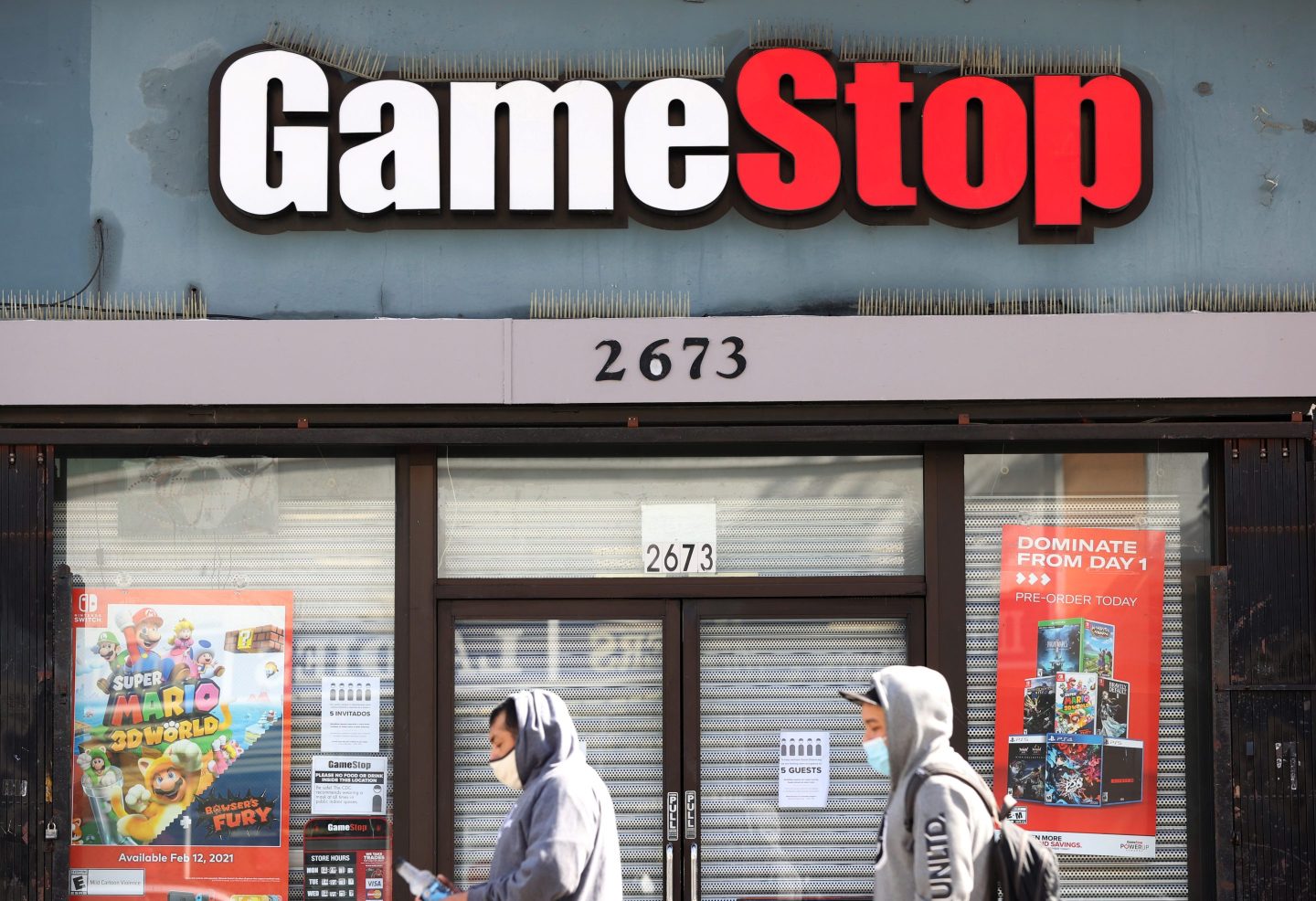 SAN FRANCISCO, CALIFORNIA &#8211; MARCH 10: Pedestrians walk by a GameStop store on March 10, 2021 in San Francisco, California. Trading of GameStop shares was halted several times on Wednesday due to volatility after the stock surged to a record high of $348.50 per share before falling to below $200 per share. The stock closed at $265 per share. (Photo by Justin Sullivan/Getty Images)