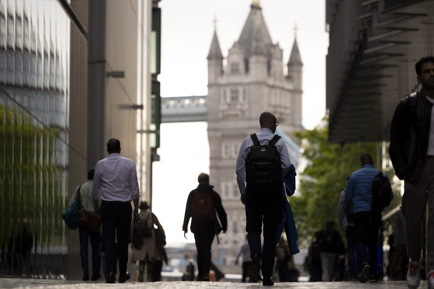 Commuters walk in view of Tower Bridge in London, UK, on Monday, May 13, 2024. British economists worried about the accuracy of official labour market data have a new concern: doubts about the number of unfilled jobs. Photographer: Jason Alden/Bloomberg via Getty Images