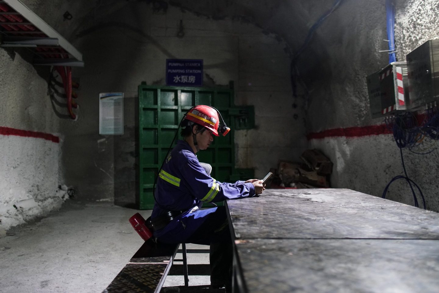 A miner browses a smartphone in a rest room underground at the Cukaru Peki copper and gold mine, operated by Zijin Mining Group Co., in Bor, Serbia, on Friday, Aug. 25, 2023. China&#8217;s Zijin is developing plans to expand its copper mine in eastern Serbia due to demand for the metal considered vital to the global energy transition  an effort that could cost billions of dollars. Photographer: Oliver Bunic/Bloomberg via Getty Images