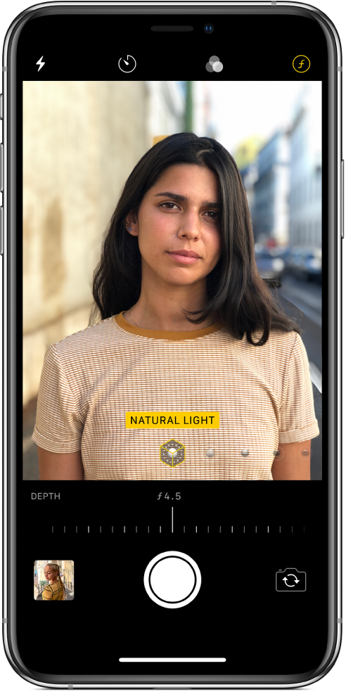 The Camera screen in Portrait mode. The Depth Adjustment button in the top-right corner of the screen is selected. In the camera viewer, a box shows that the Portrait Lighting option is set to Natural Light, and there’s a slider to change the lighting option. Below the camera viewer, there’s a slider to adjust the Depth Control.