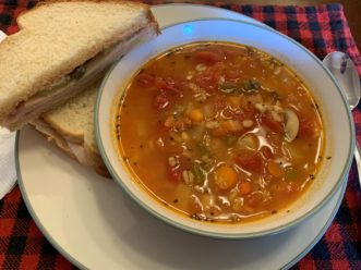 The roasted vegetable and barley soup served with a turkey sandwich.
