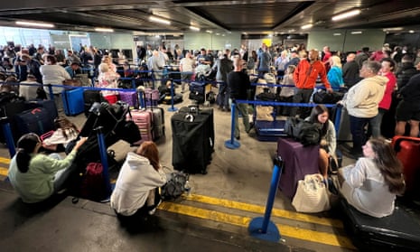 Manchester airport passengers stuck in long queues after power cut – video 