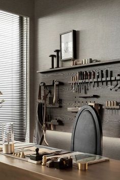 a wooden desk topped with lots of tools and decor on it's wall next to a window