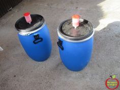 two blue coolers sitting next to each other on the ground with lids and handles