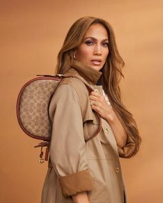 a woman in trench coat carrying a brown backpack with leopard print on the front and back