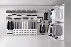 an organized closet with clothes, shoes and other items on shelves in black and white