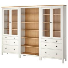 a white bookcase with drawers and shelves