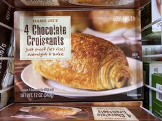 an assortment of chocolate croissants on display in a grocery store's deli
