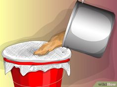 a hand that is reaching into a red bucket