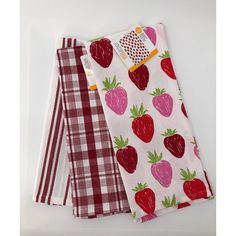 three napkins with strawberries printed on them