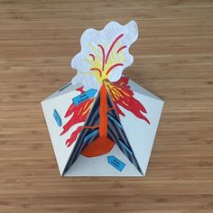 an origami firecracker on a wooden table
