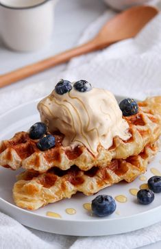 waffles topped with blueberries and whipped cream